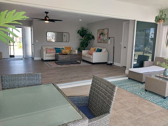 large glass sliders open to the lanai for indoor & outdoor living