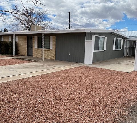 Side view of home-corner lot. Carport area.