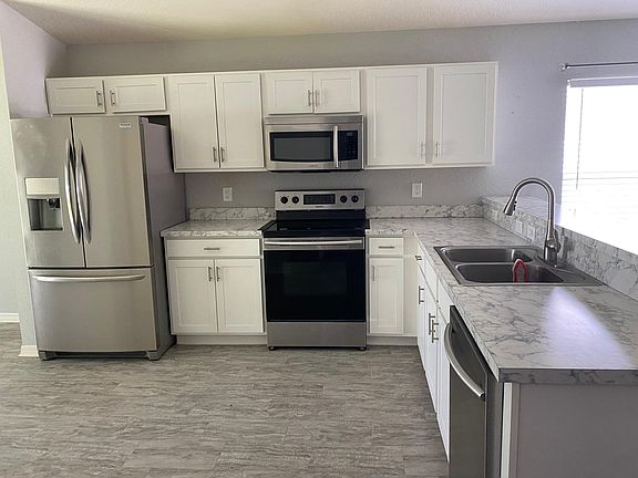 Large eat in kitchen with lots of cabinets. All appliances included