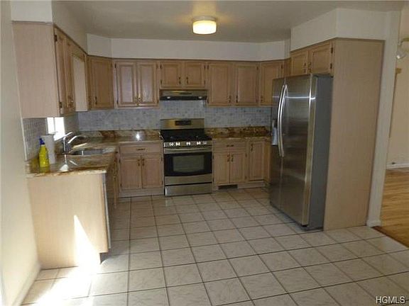 Very large eat in Kitchen with sliding glass doors that leads to fenced in yard.