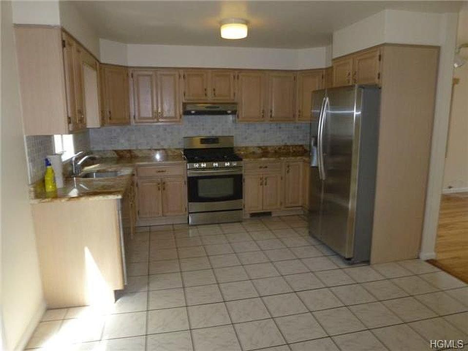 Very large eat in Kitchen with sliding glass doors that leads to fenced in yard.