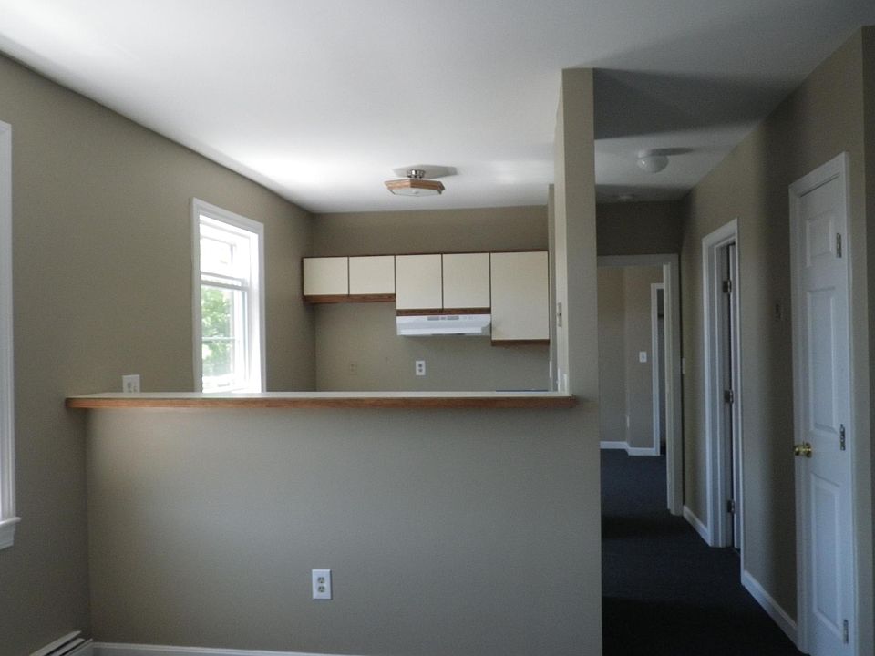 Kitchen (this is OLD kitchen), new photos available next week. Grey cabinets to ceiling, all new appliances, stone counter tops. Photos available next week.