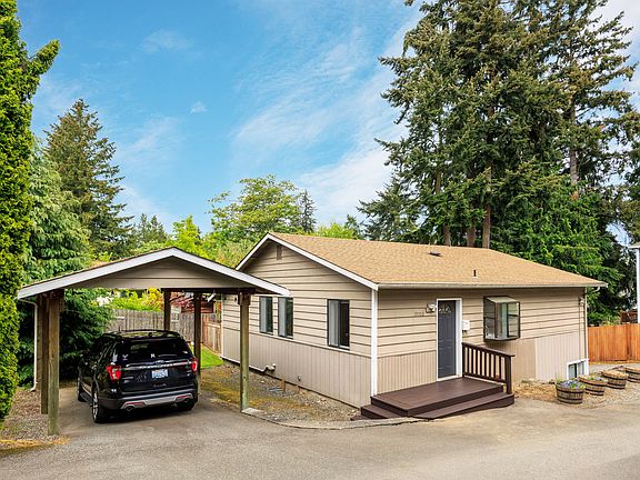 Front of home with carport parking