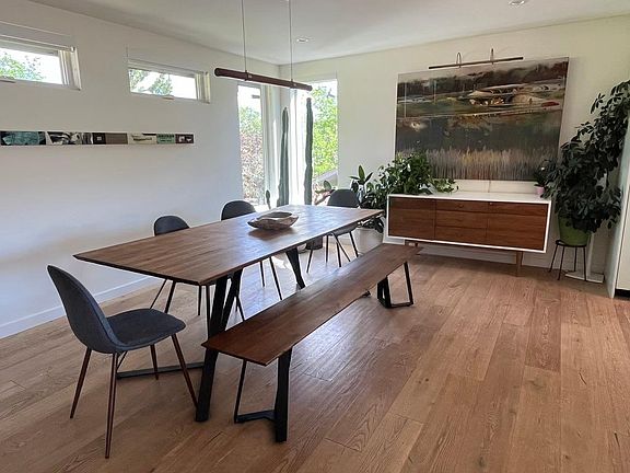 Open plan dining area with art sourced from Santa Fe's Canyon Road. Furnished, partially furnished or unfurnished terms available.