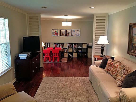 Louvered panels make a division between the formal living and dining rooms.