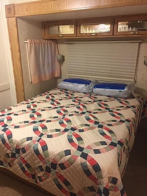 QUEEN SIZE BED W/ NEW PILLOWS AND MATTRESS PAD. YOU HAVE TO PROVIDE YOUR OWN SHEETS AND TOWELS. THERE IS A BIG STORAGE AREA UNDERNEATH FOR OUT OF SEASON CLOTHES.