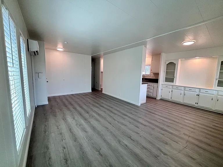The living room welcomes you with an open, inviting layout designed for both comfort and functionality. Large windows allow natural light to fill the space, creating a bright and airy atmosphere.