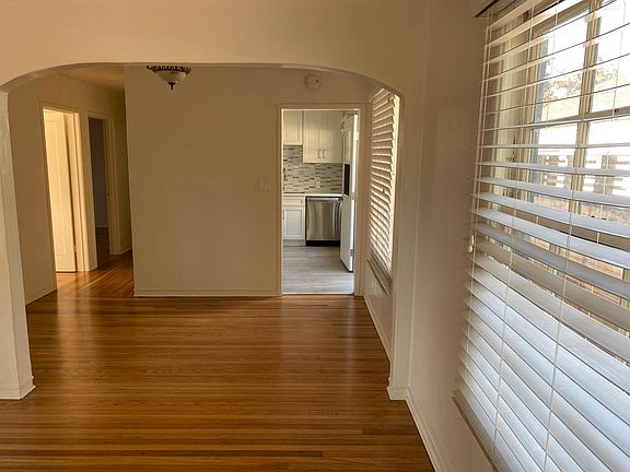 Dining area with a view toward kitchen (right) and hallway (Left) leading to both bedrooms and bathroom.