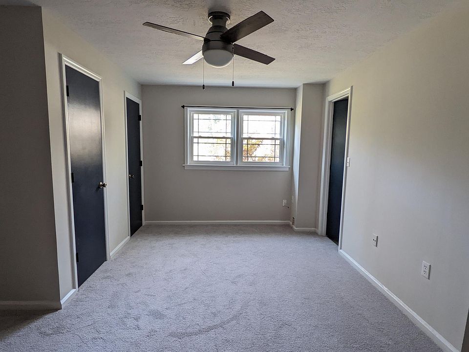 Large bedroom with nice windows, brand new carpet, ceiling fan, a bathroom, and THREE closets!