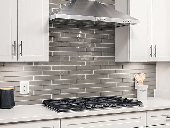 Stainless Steel Appliances and Hood Vent in the Gourmet Kitchen