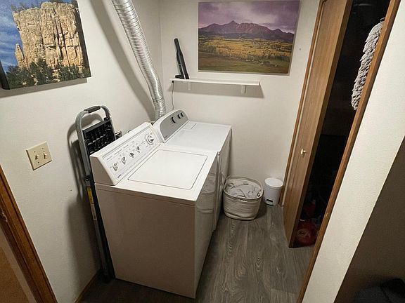 laundry room with washer and dryer, extra storage closet