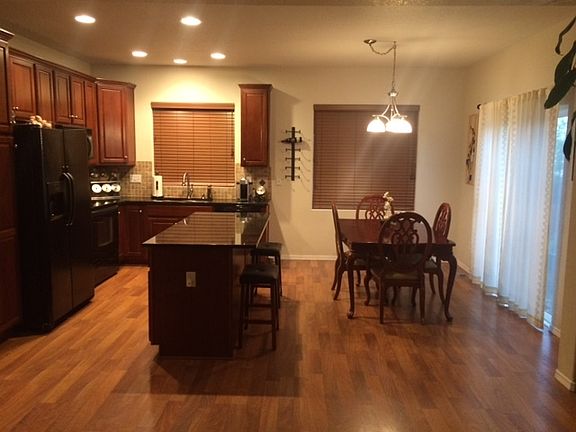 Open Kitchen w/ Granite Countertops : Eat in kitchen area includes wood laminate floorings and grani