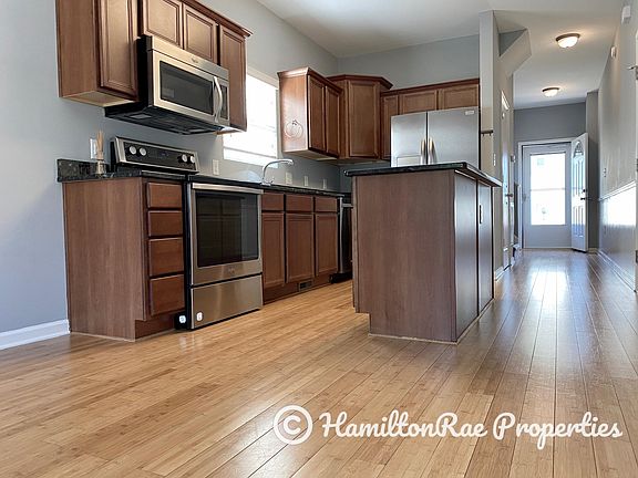 Kitchen, front hallway, and front entrance. Tons of natural light.