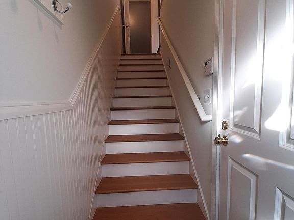 Heading up stairs from entrance - garage entrance to right