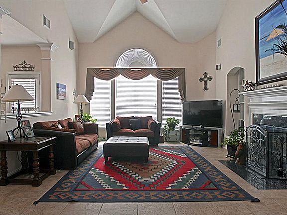 The living room has a "Grandness" with the high ceilings that offer an architectural touch.  It is expansive in size and still open to the Dining, Breakfast, and Kitchen areas.  Additionally there is surround speakers, Fireplace, & Tile floors.