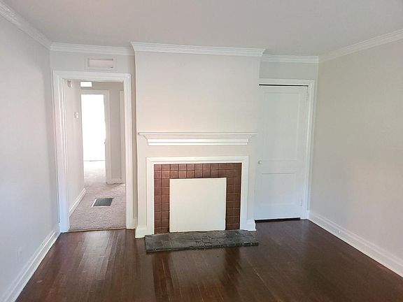 Family Room with Beautiful Hardwood Floors Opens to Kitchen and Hallway