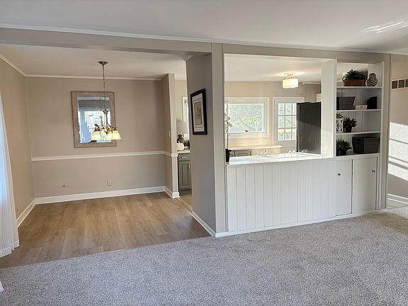 Open floor plan with tons of light. New flooring in the dining room and kitchen. New carpet in family room and all the bedrooms.