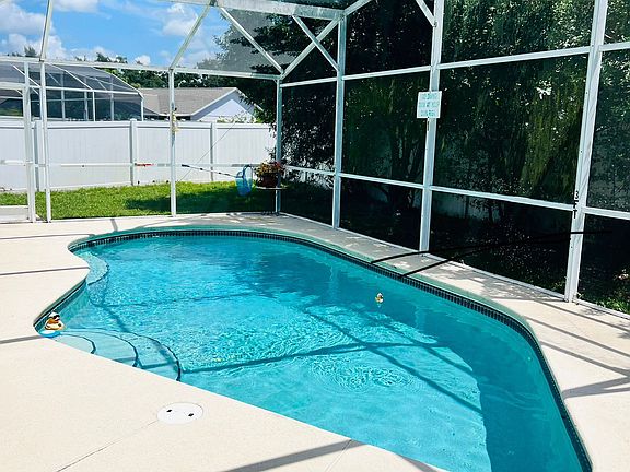 Private screened swimming pool with fenced backyard _ ideal for relaxation and privacy.