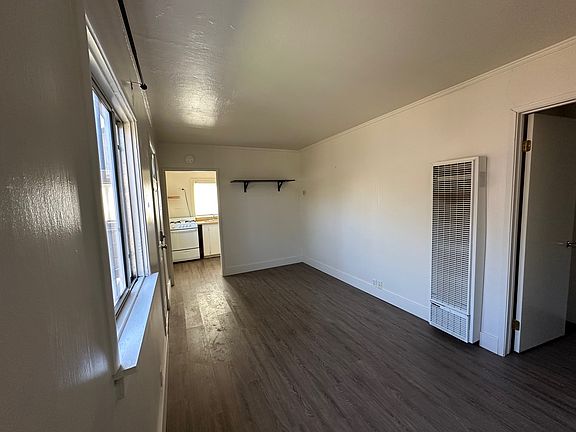 living room, looking towards kitchen. (bedroom is open door on the right)