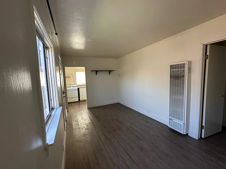 living room, looking towards kitchen. (bedroom is open door on the right)