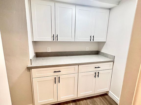 Lots of storage off kitchen for pantry or media charging area