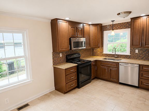 View of Kitchen from Dinette Area - Edited with AI to remove personal items and furniture.