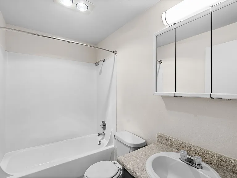 Clean bathroom with tub and vanity Clean bathroom with tub and vanity