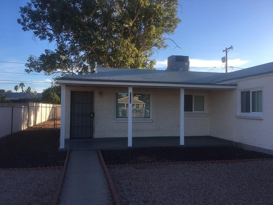 Front porch and fenced-off front yard