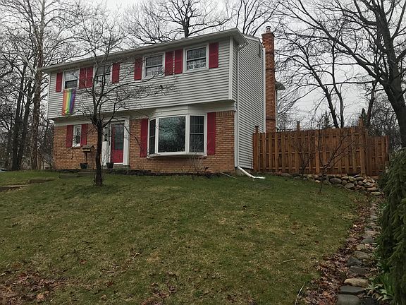 Side view of the house that shows the fenced in backyard. 