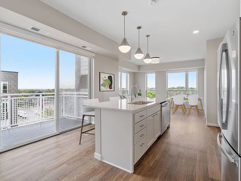Open-concept kitchen & living room at | The Hallon Luxury Apartments in Hopkins MN