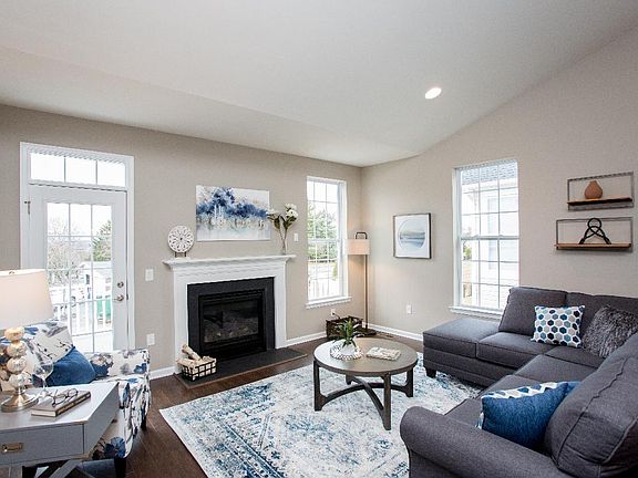 Family room is the perfect setting for relaxation with its cozy fireplace and ample natural light
