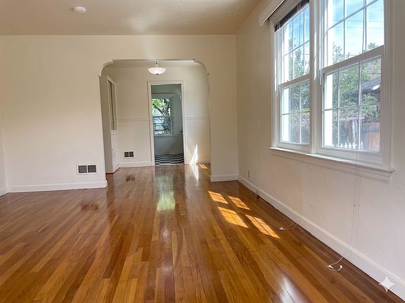 Living room with a peek of the dining room and kitchen.