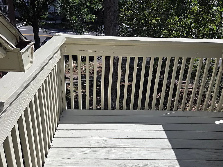 Balcony looking onto yard and 22nd Ave