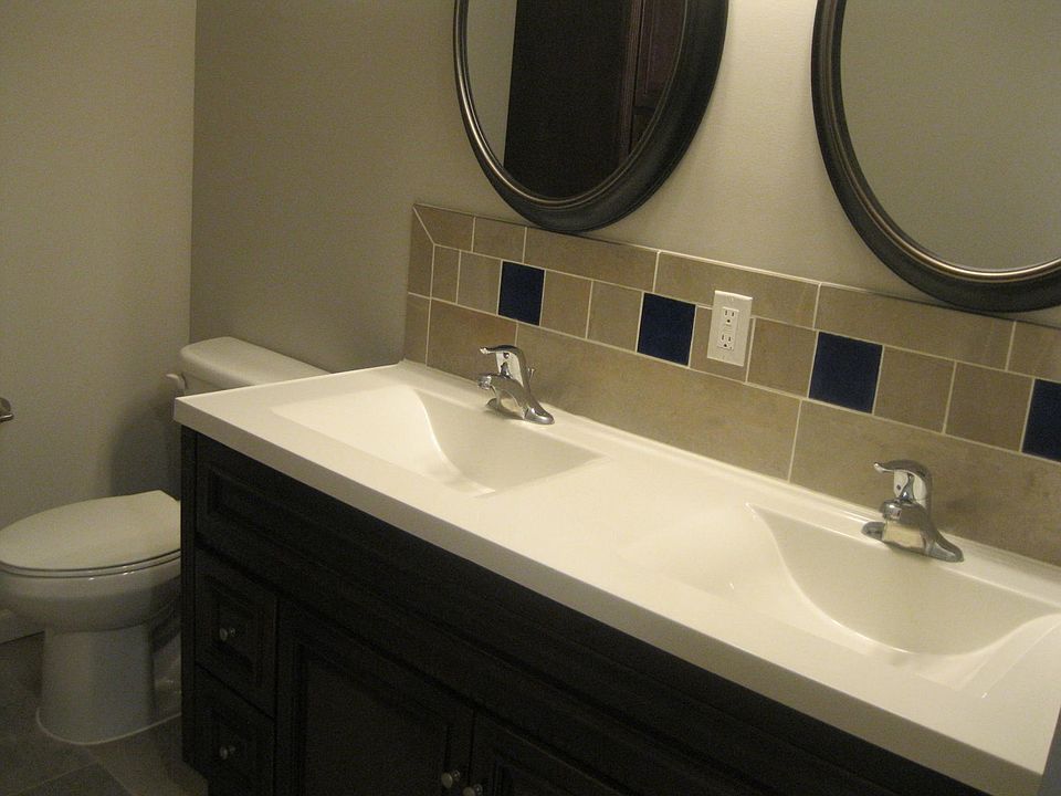 Double sink vanity and tile floors and showers