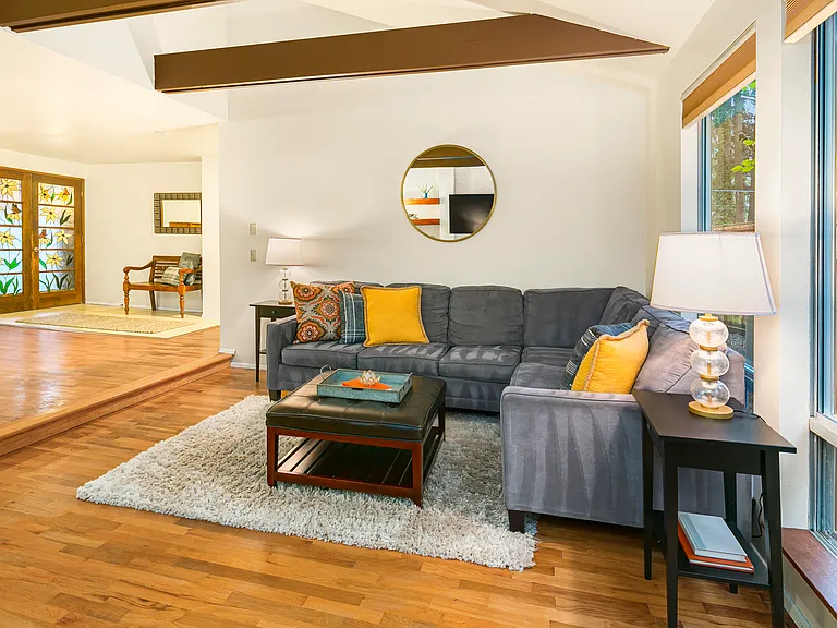 Formal living with vaulted ceilings. Large windows bring ample light in.