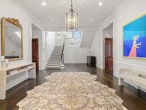 Grand entry foyer introduces rich hardwood floors, high ceilings and an intelligently reimagined layout.