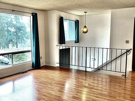 Spacious main living area with large windows.