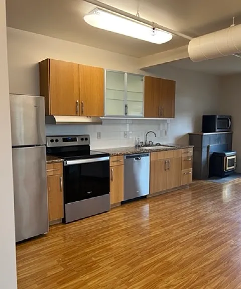 Kitchen with new stainless steel appliances.