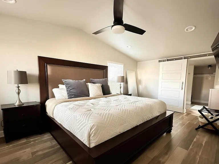Larger Master bedroom with tall, vaulted ceilings and ensuite Master bathroom