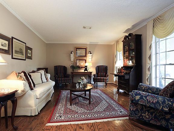Formal living room shown here is off the entry and could also be utilized as a wonderful study, playroom, gameroom or music room. This pretty room also features hardwood flooring.