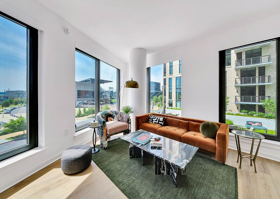 Open-concept living room with spacious size and large windows.
