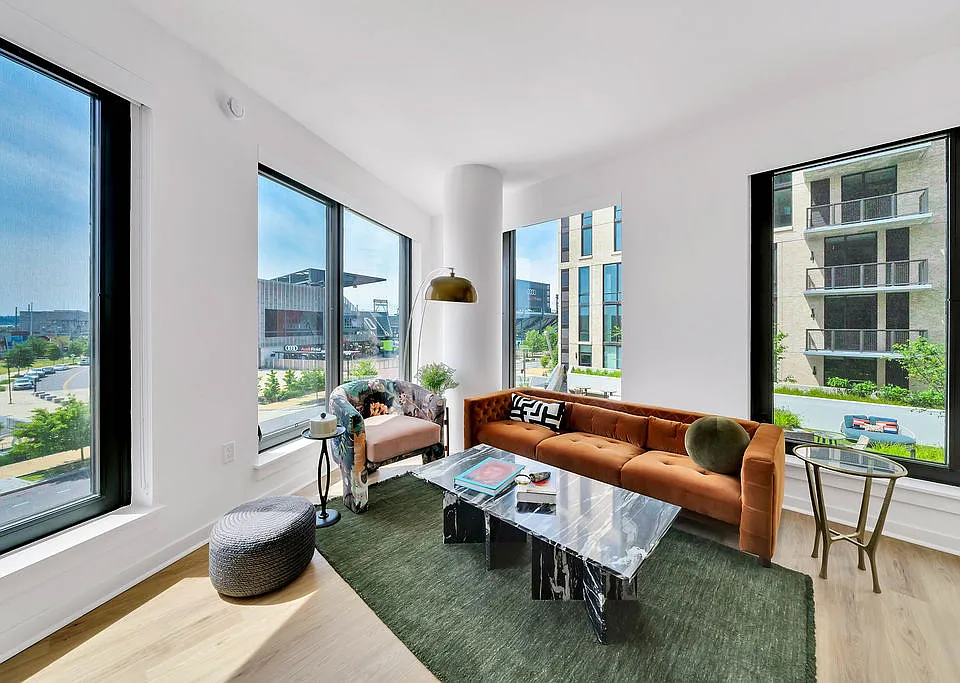 Open-concept living room with spacious size and large windows.