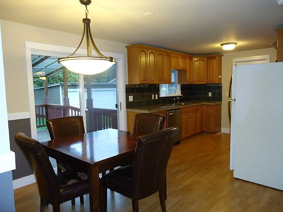 Eating space off the kitchen allows easy access to the huge covered deck. Not the detached garage in the huge rear yard.