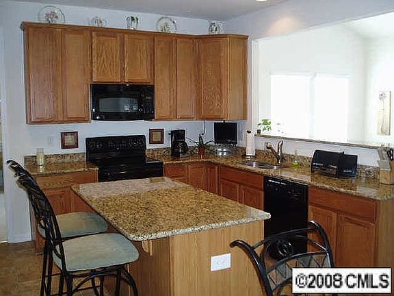 Kitchen with island and sunroom