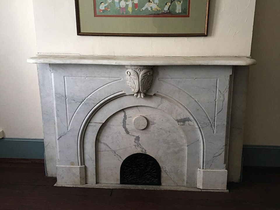 Marble living room mantle with original hardwood flooring