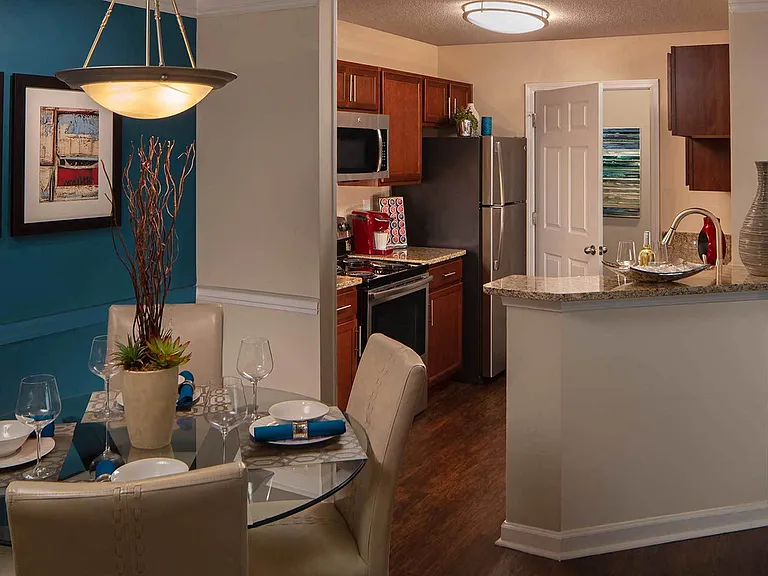 Kitchen with stainless steel appliances, bar area and wood style flooring