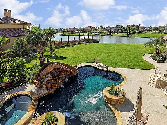 Balcony view of the pool, spa, backyard, and 20 acre area lake with 9 lighted fountains and 6 docks.