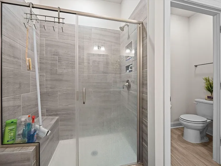 Downstairs master bathroom with walk in shower and shower bench