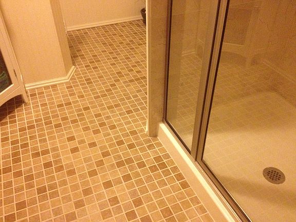 Ceramic tile floor and marble tile shower.