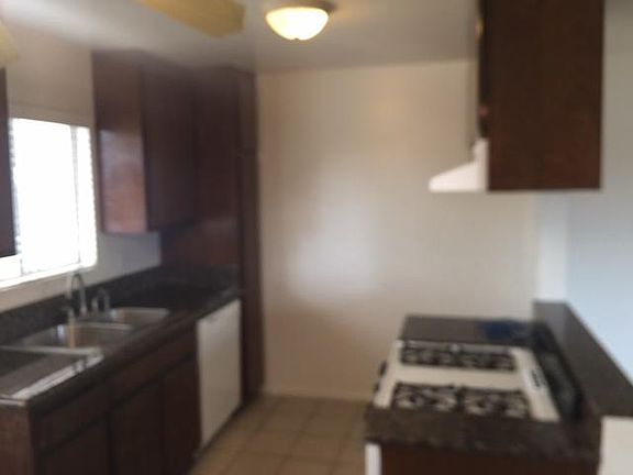 Kitchen with dishwasher, stove oven, stainless steel sink and granite counter tops